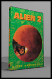 Alien 2 (1980) DVD cover featuring a caver with a helmet against a dramatic orange moon background.